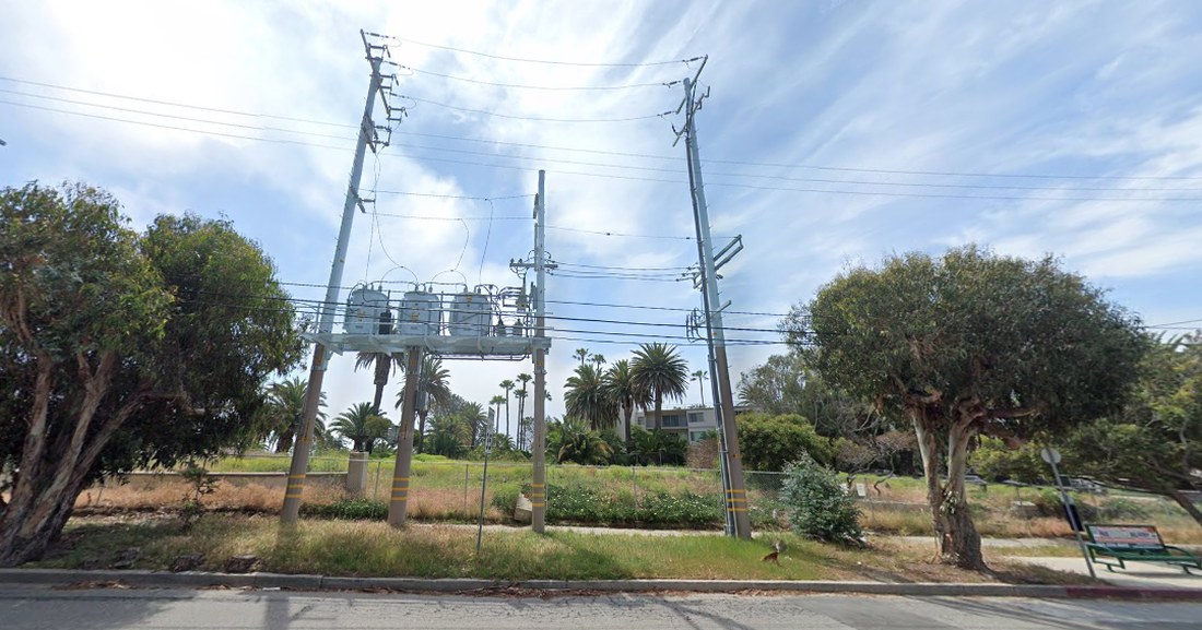 The existing PTDS on Sunset Boulevard surrounded by green trees and palms, photographed before the 2025 fires.
